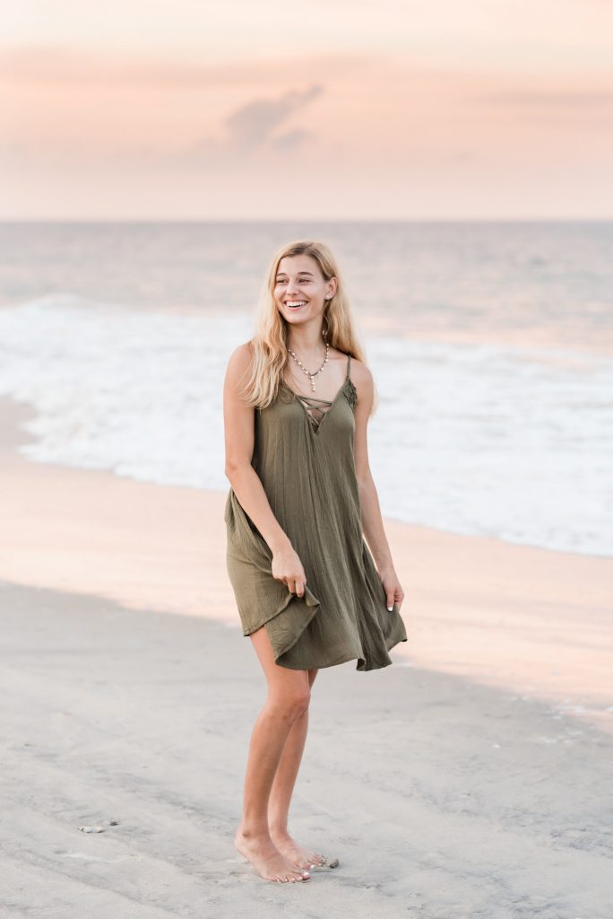 Virginia Beach high school senior photographer girl standing on the beach looking away